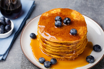 Pumpkin pancakes with maple syrup and blueberries