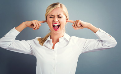 Young woman blocking her ears