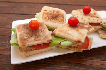 Small sandwiches with salmon, cheese and vegetables