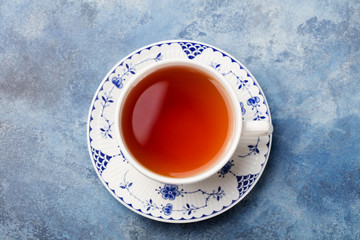 Cup of tea on a blue stone background. Top view