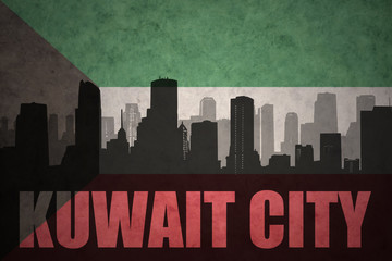 abstract silhouette of the city with text Kuwait City at the vintage kuwait flag background