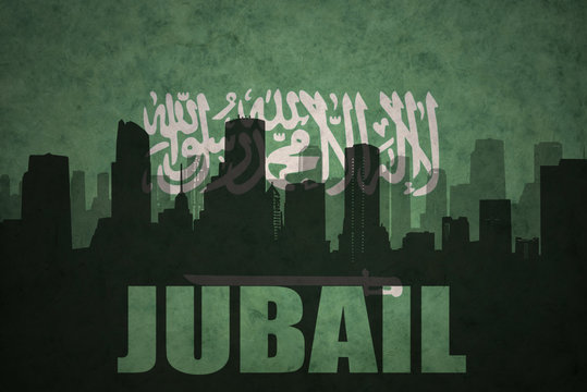 abstract silhouette of the city with text Jubail at the vintage saudi arabia flag background