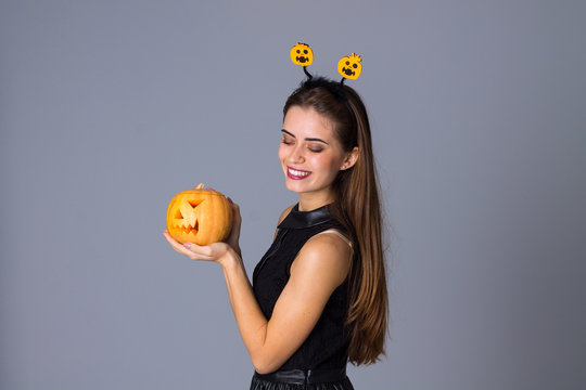 Woman With Handband Holding A Pumpkin 