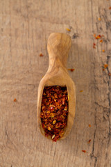 dried tomatoes as spice in a wooden scoop