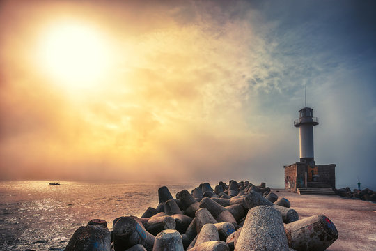 Lighthouse in misty sea