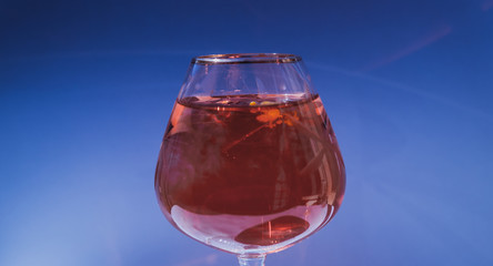 Wine glass filled with red and yellow ink