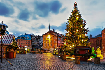 Christmas tree with illumination and the Dome square with Riga Christmas market stalls  in the...
