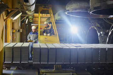 Plant workers unloaded the cart with bricks from the kiln