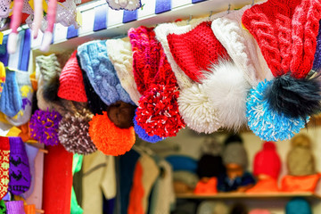 Pom pom hats hanging for sale at Riga Christmas market