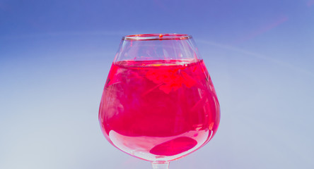 Wine glass filled with red and yellow ink