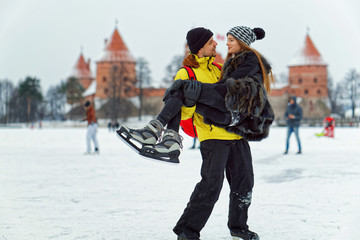 Young girl and fellow at rink in Trakai