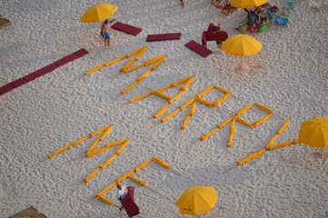 Marry Me spelled with beach umbrellas