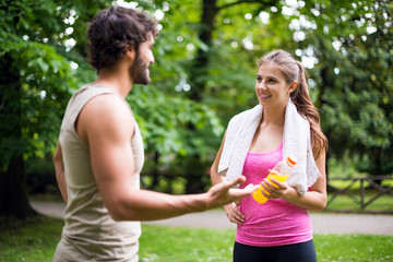 Couple talking after training in a park