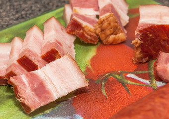 Bacon cut into slices over board. Preparing ingredient.