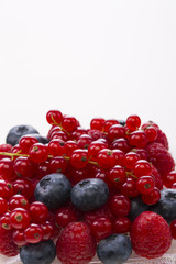 border of fresh berries with green, leaves isolated