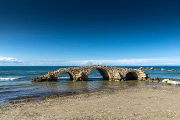 Fototapeta na wymiar medieval bridge in the water at Argassi beach, Zakynthos island, Greece