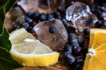 Juniper berries and lemons for gin - obrazy, fototapety, plakaty