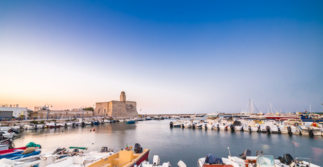 Ancient lighthouse in a town in Puglia in Italy