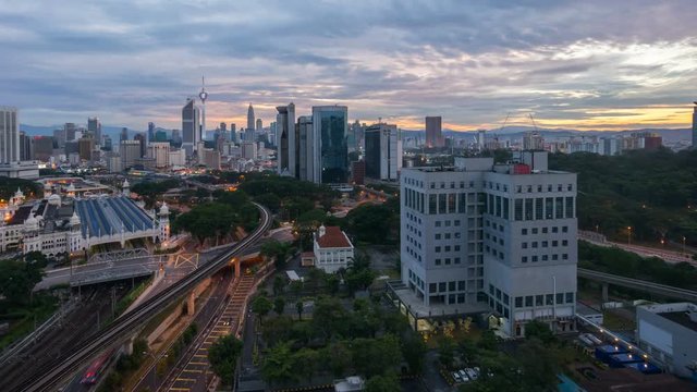 Time lapse 4k Footage of a beautiful Sunrise At Kuala Lumpur, Malaysia. Showing a moving cars with the light trail and sun rise from the horizon line. Tilt up