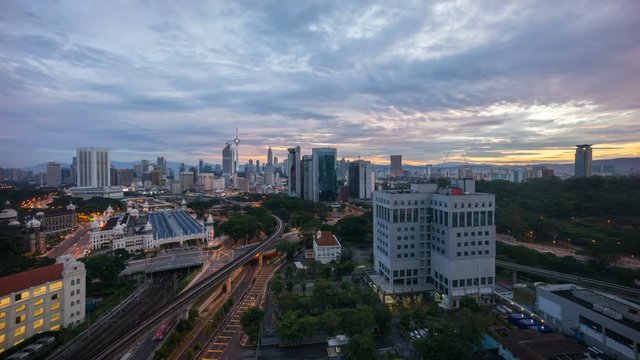 Time lapse 4k Footage of a beautiful Sunrise At Kuala Lumpur, Malaysia. Showing a moving cars with the light trail and sun rise from the horizon line