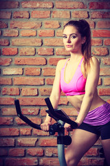 Fototapeta na wymiar Active woman doing sport biking.