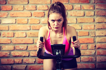Obraz na płótnie Canvas Active woman doing sport biking.