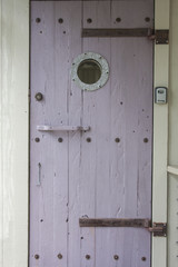 A ship door with a porthole
