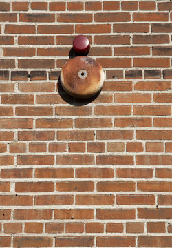 Brick wall and alarm bell background and texture. © geraldmarella
