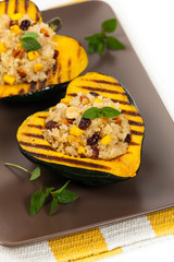 Pumpkin Stuffed with Quinoa, Nuts and Dried Fruit Isolated on a white background. Selective focus.