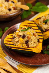 Pumpkin Acorn Stuffed with Quinoa, Nuts and Dried Fruit. Selective focus.