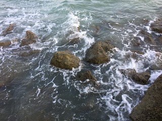 Rocky beach by the sea wave refreshing atmosphere.