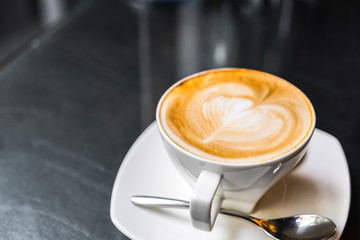 Latte Coffee art on the table .