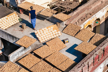 Baker drying bread on rooftop in New Delhi India