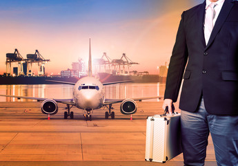 business man and briefcase standing against cargo plane in transportation background