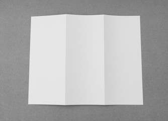 Trifold white template paper on gray  background .