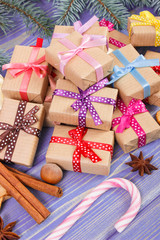 Wrapped gifts with ribbons for Christmas, spices and spruce branches