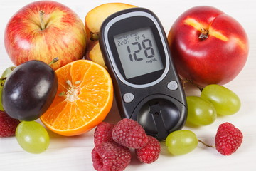 Glucometer and fresh fruits, diabetes and healthy nutrition