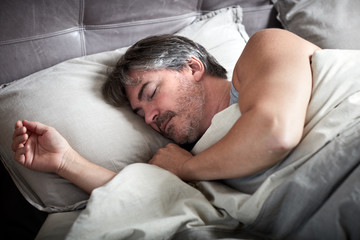 Man sleeping in bed.