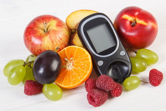 Glucometer and fresh fruits, diabetes and healthy nutrition
