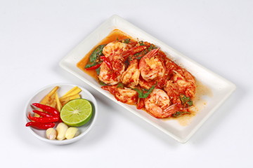 Fried spicy basil with shrimp and side dish as halve green lemon ,red chili and garlic are popular Thai food. 
