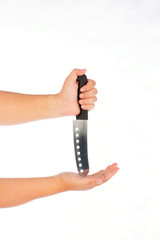 knife threatening hand that is lying on a white background