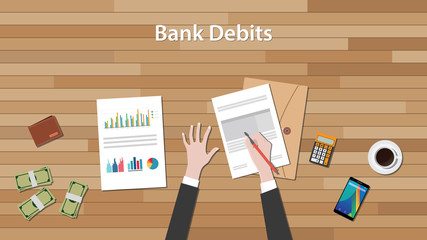 bank debits concept with business man work on paper document  chart and graph  top of wooden table