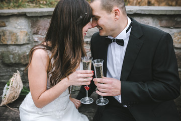 Beautiful wedding couple drinking champagne
