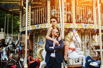 Fototapeta na wymiar adult man and woman on a carousel