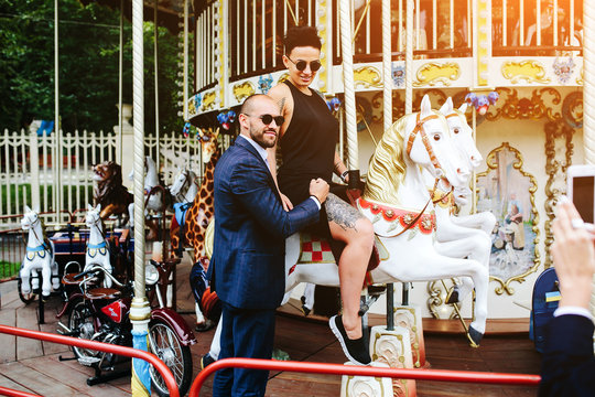 adult man and woman on a carousel