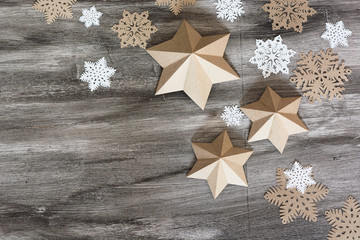 Christmas decoration stars and snowflakes on the grey wooden background. Christmas card. Mock up with text space