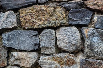 Fragment of the wall made of stones of granite