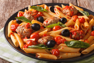 Italian Food: Pasta with meatballs, olives and tomato sauce closeup. horizontal
