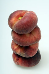 Flat peaches on light background