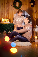 A couple or husband and wife in a house decorated in anticipation of the New Year or Christmas